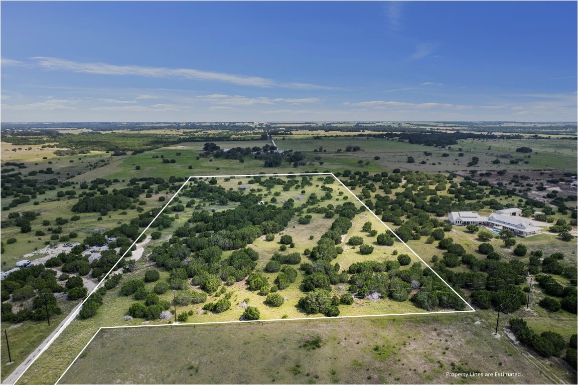 an aerial view of a houses with a yard