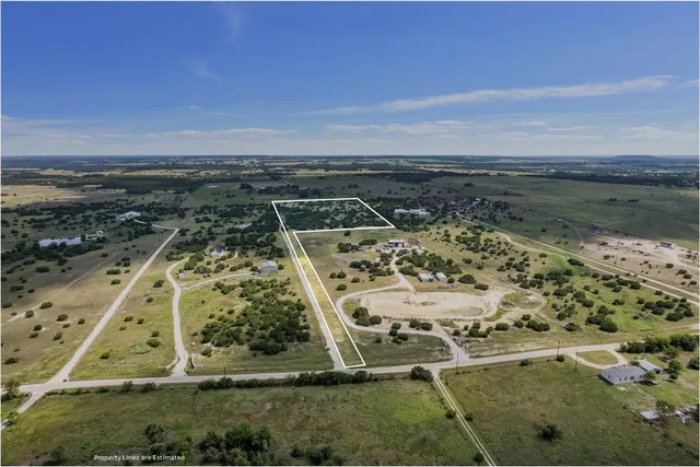 an aerial view of a residential houses with outdoor space