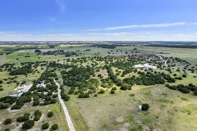 an aerial view of a houses with a yard