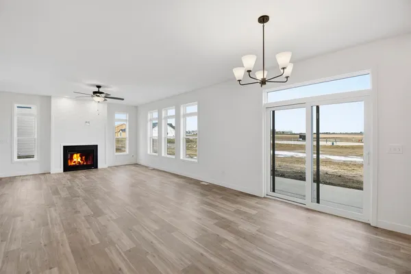 an empty room with windows and fireplace
