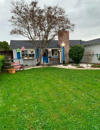 a house view with a sitting space and garden