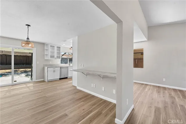 a view of a kitchen with wooden floor and a sink