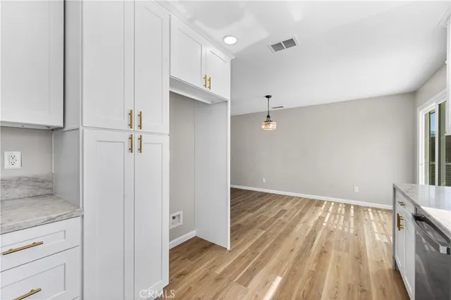 a view of a hallway with wooden floor and closet