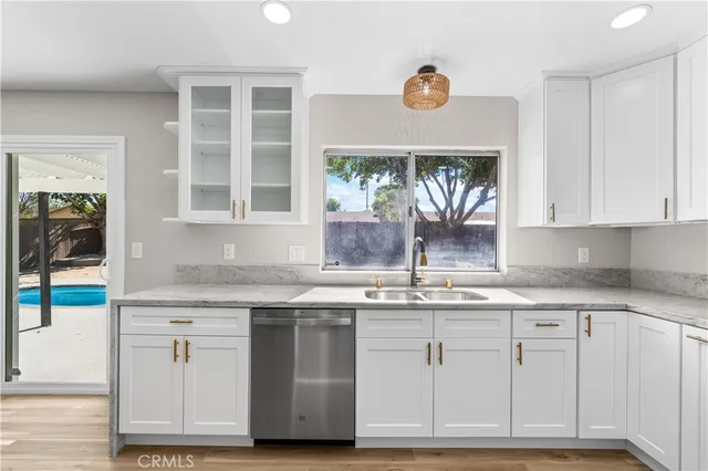 a kitchen with granite countertop white cabinets and white appliances