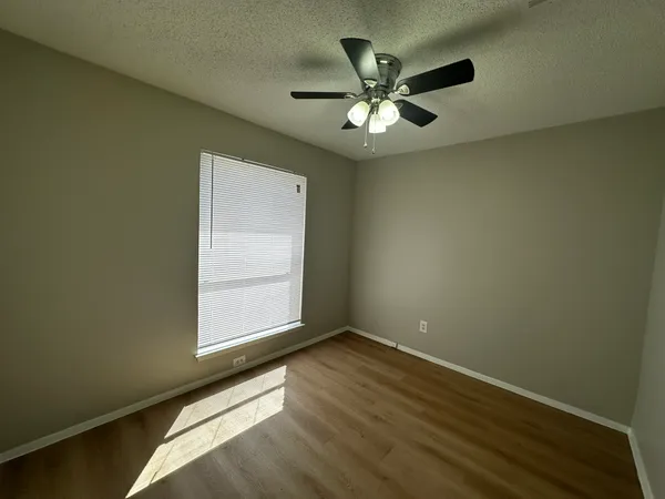 a view of room with window and ceiling fan