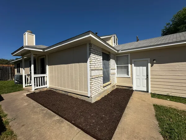 a view of a house with wooden fence