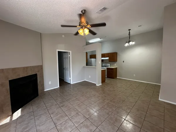 a view of a kitchen with a sink and a fireplace