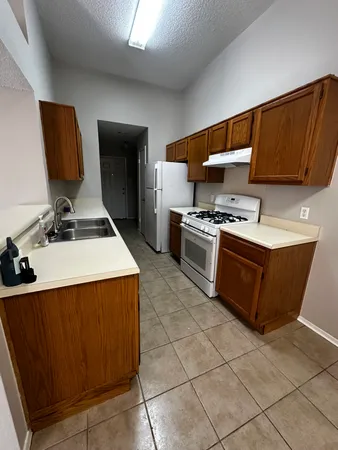 a kitchen with cabinets and steel appliances