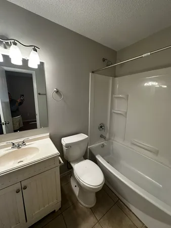 a view of a room with a ceiling fan and a window