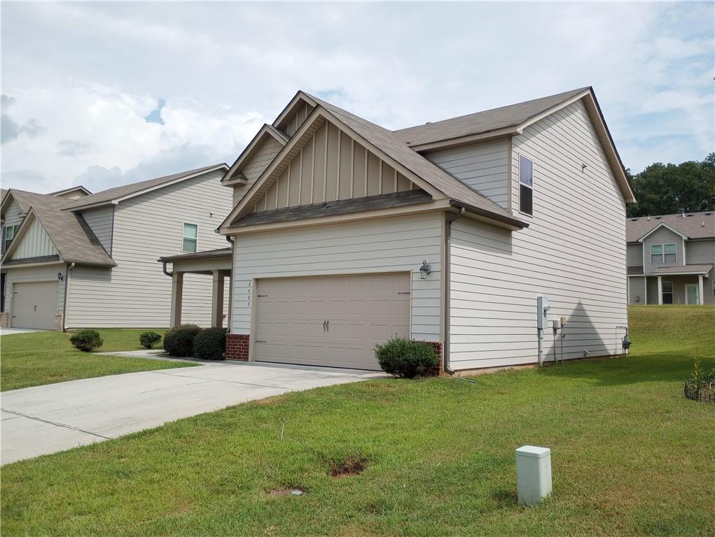 2408 Quincy Loop Fairburn, GA 30213 - Photo 1 of 1 a front view of a house with a yard and garage