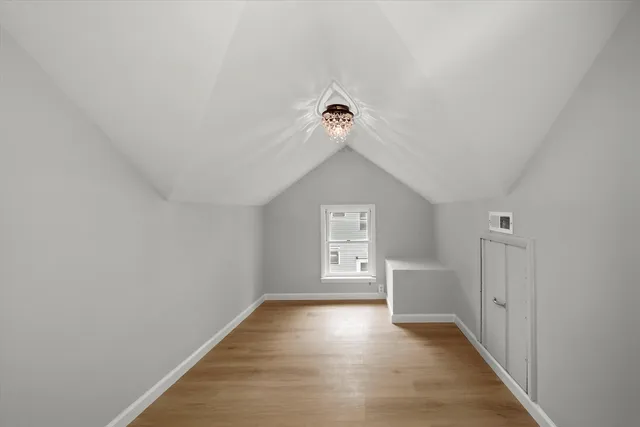a view of a room with wooden floor and windows