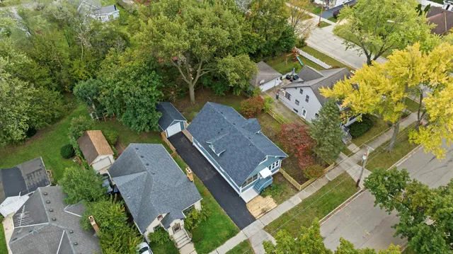 an aerial view of a house with swimming pool and garden