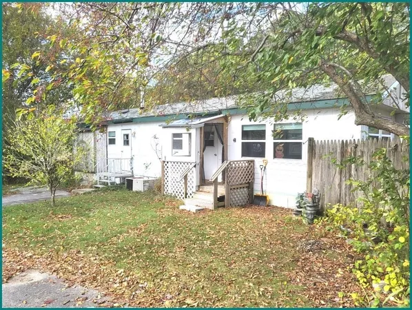 a house that has a tree in front of it