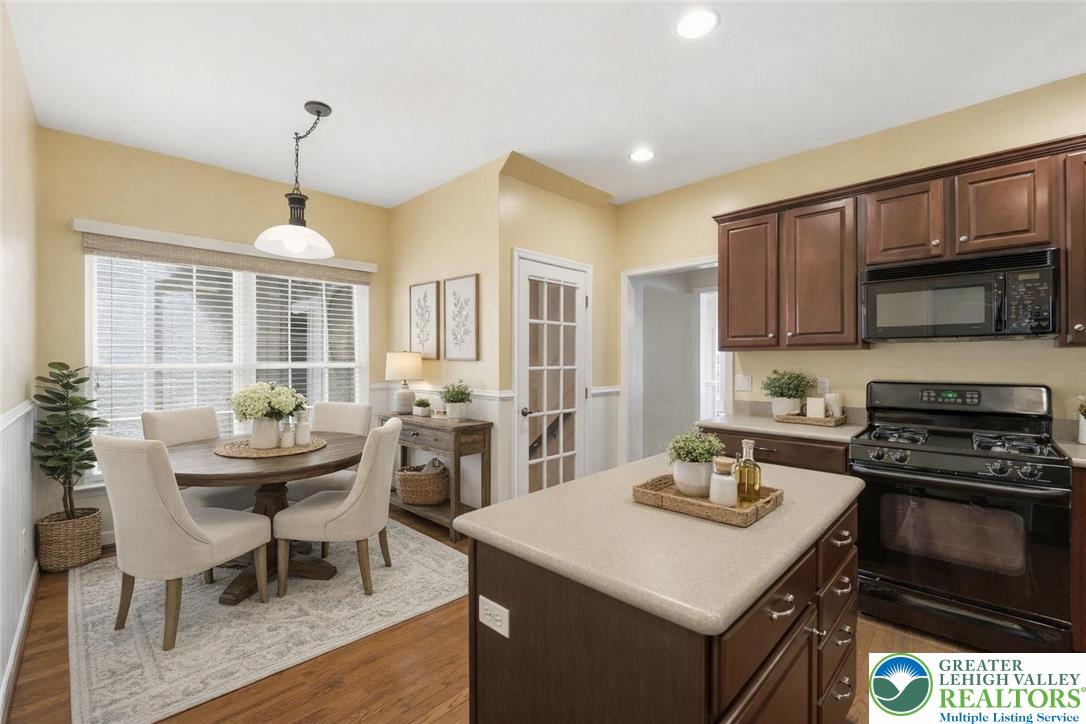 2493 Thistle Road Lower Macungie Township, PA 18062 - Photo 11 of 38 a kitchen with a stove a table and chairs in it