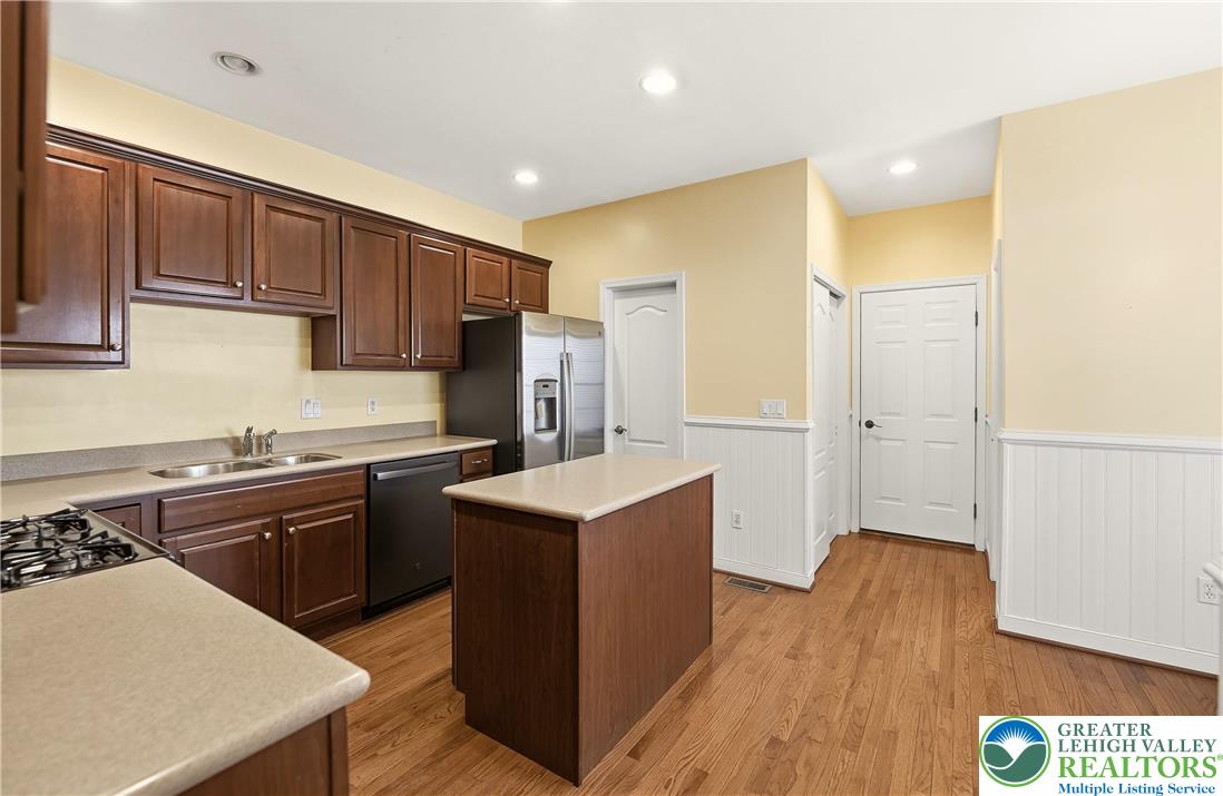 2493 Thistle Road Lower Macungie Township, PA 18062 - Photo 12 of 38 a kitchen with a sink a stove a refrigerator cabinets and wooden floor