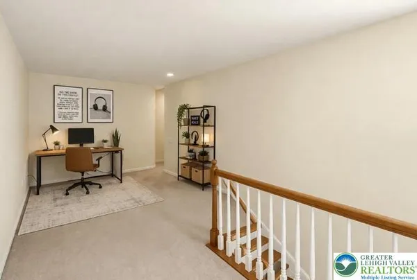 a view of a hallway with furniture and wooden floor