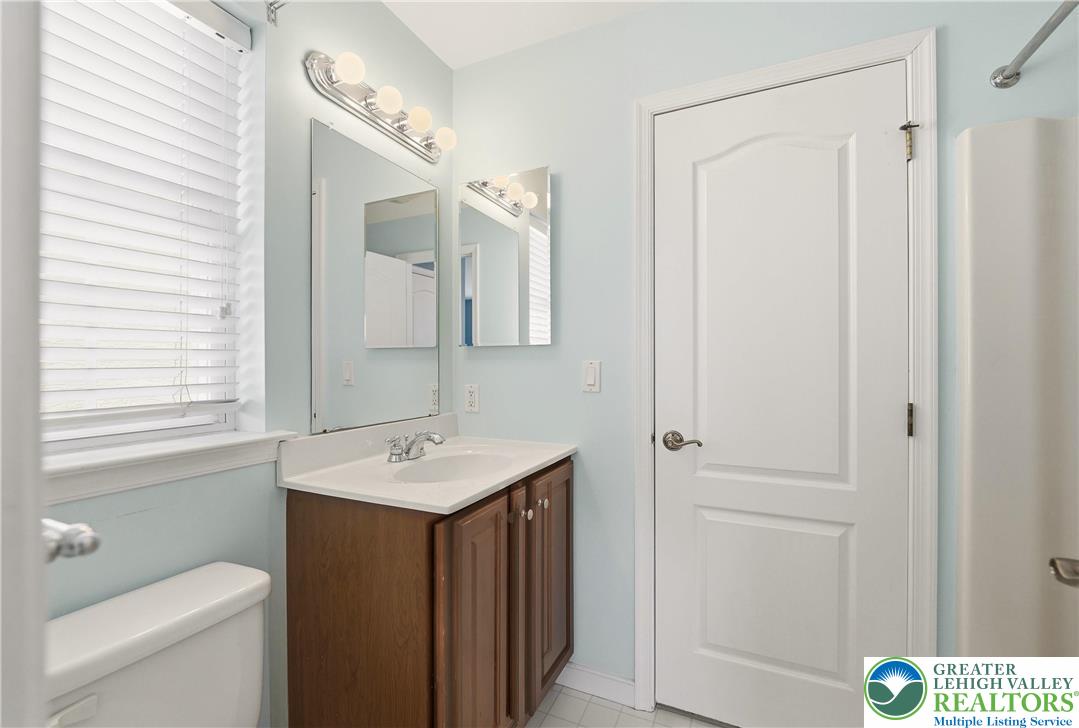 2493 Thistle Road Lower Macungie Township, PA 18062 - Photo 28 of 38 a bathroom with a sink a toilet and a mirror