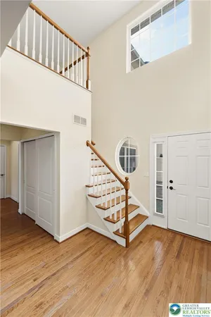 a view of staircase with white walls and a window