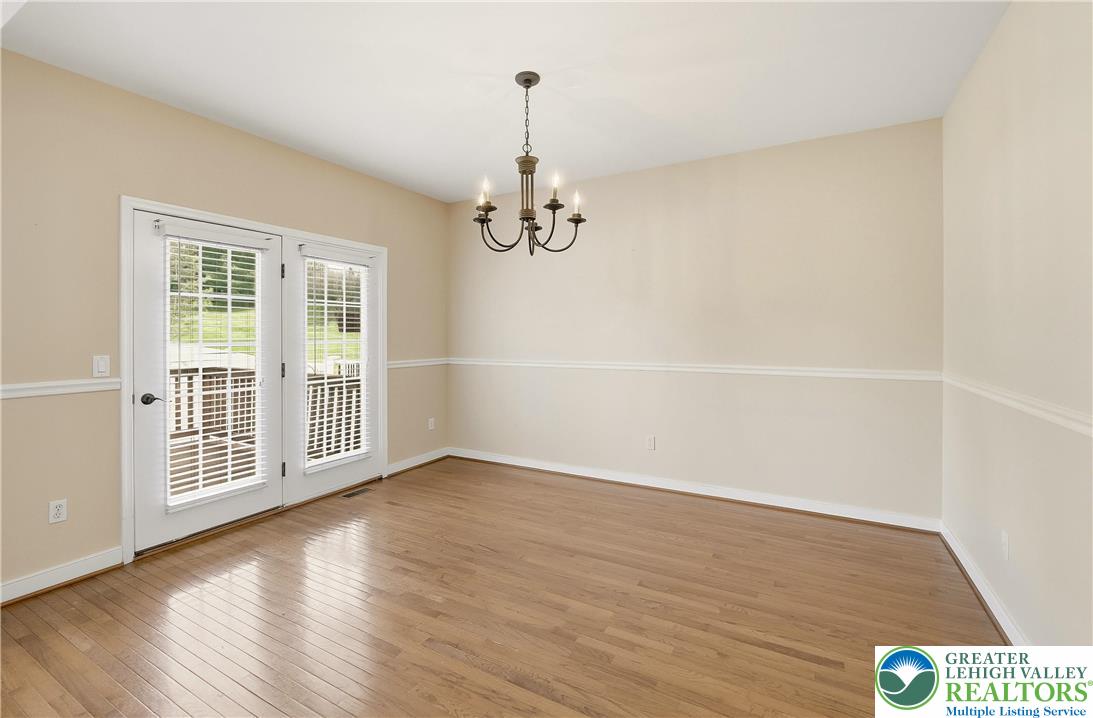 2493 Thistle Road Lower Macungie Township, PA 18062 - Photo 8 of 38 wooden floor in an empty room with a window