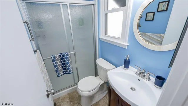 a white toilet sitting next to a bathroom sink