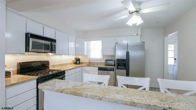 a kitchen with a refrigerator sink and stove