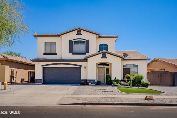 a front view of a house with a yard and garage
