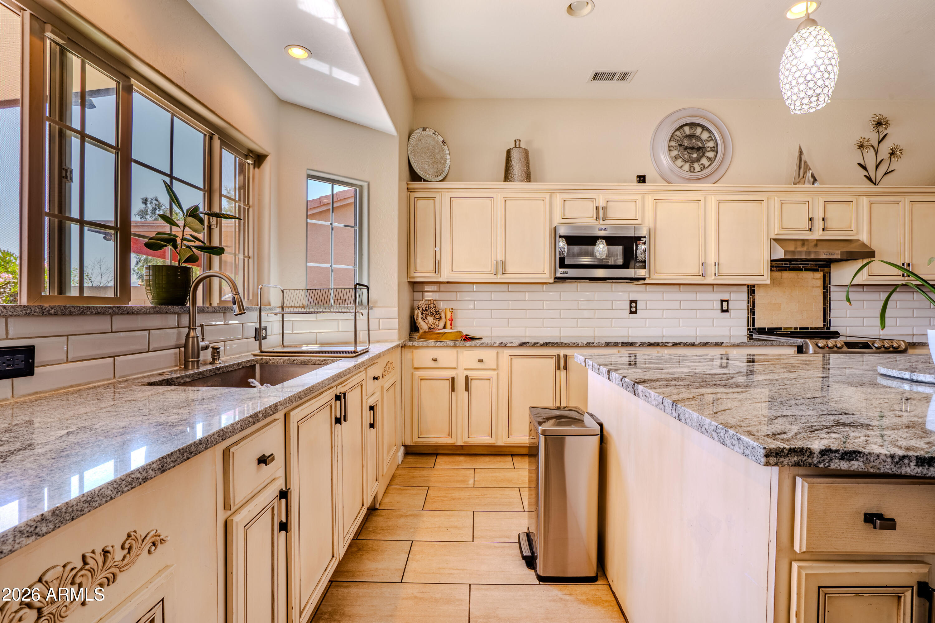 5137 West Grenadine Road Laveen, AZ 85339 - Photo 15 of 53 a kitchen with stainless steel appliances granite countertop a sink and a stove