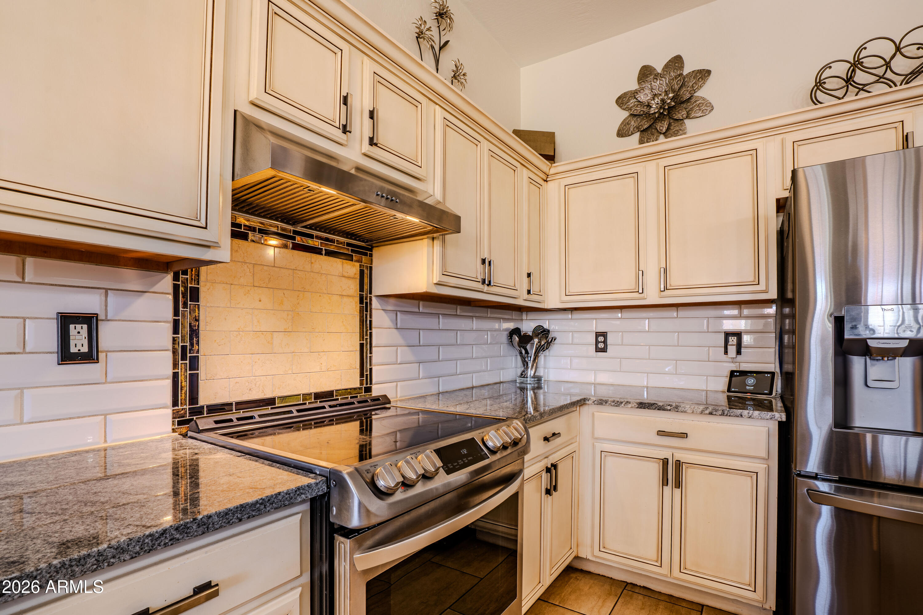 5137 West Grenadine Road Laveen, AZ 85339 - Photo 17 of 53 a kitchen with stainless steel appliances granite countertop a stove and a refrigerator