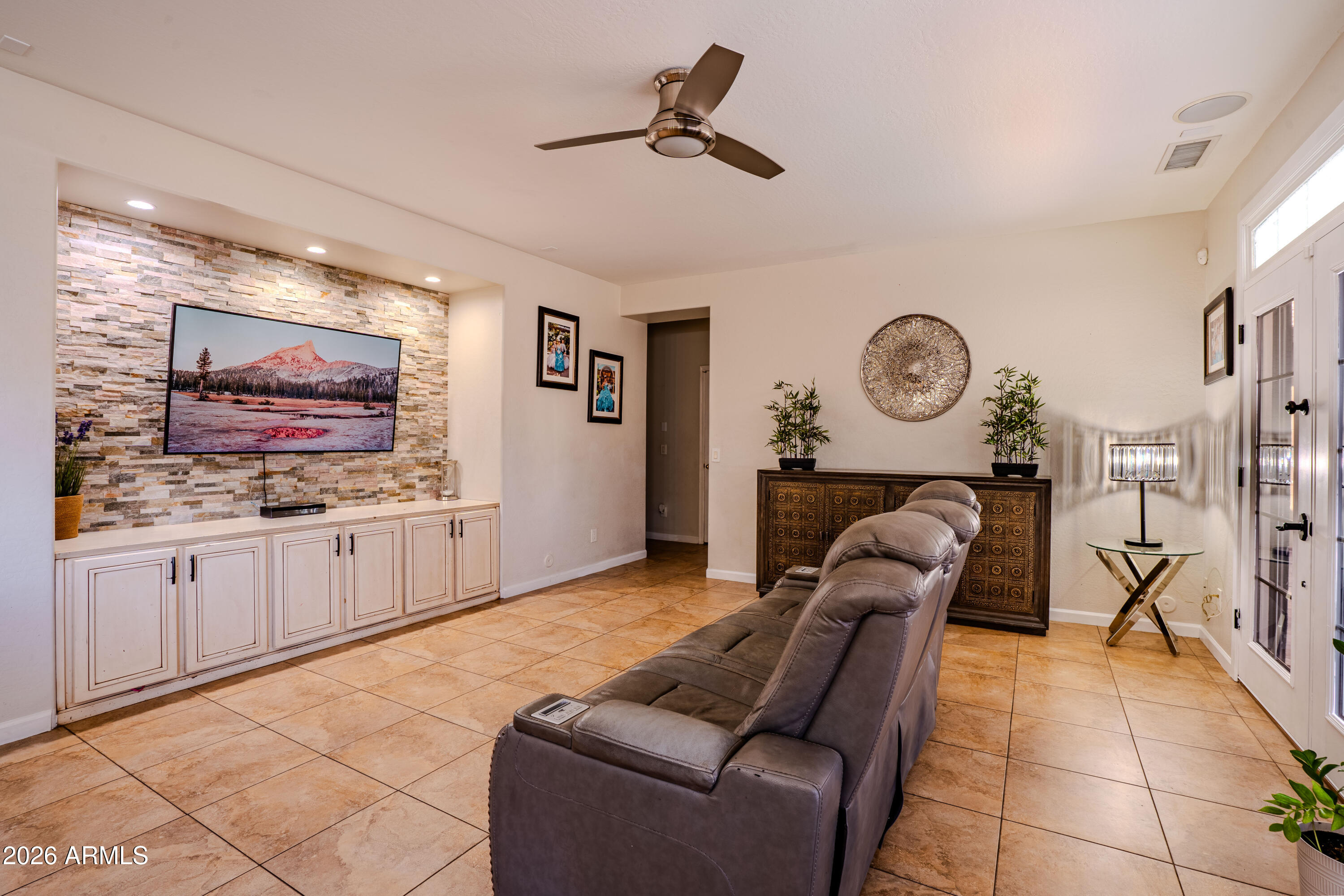 5137 West Grenadine Road Laveen, AZ 85339 - Photo 18 of 53 a living room with furniture and a flat screen tv