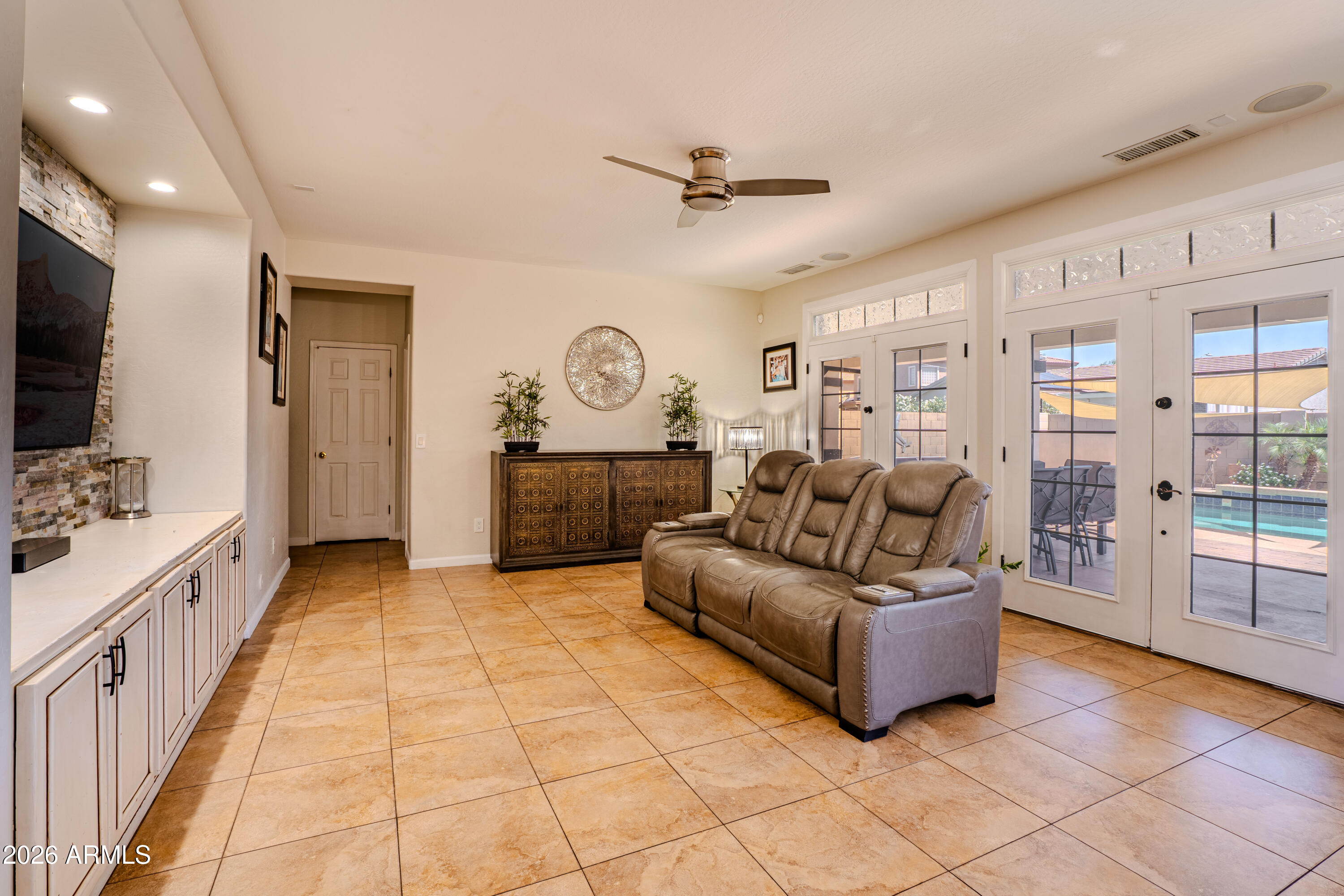 5137 West Grenadine Road Laveen, AZ 85339 - Photo 19 of 53 a living room with furniture and a flat screen tv