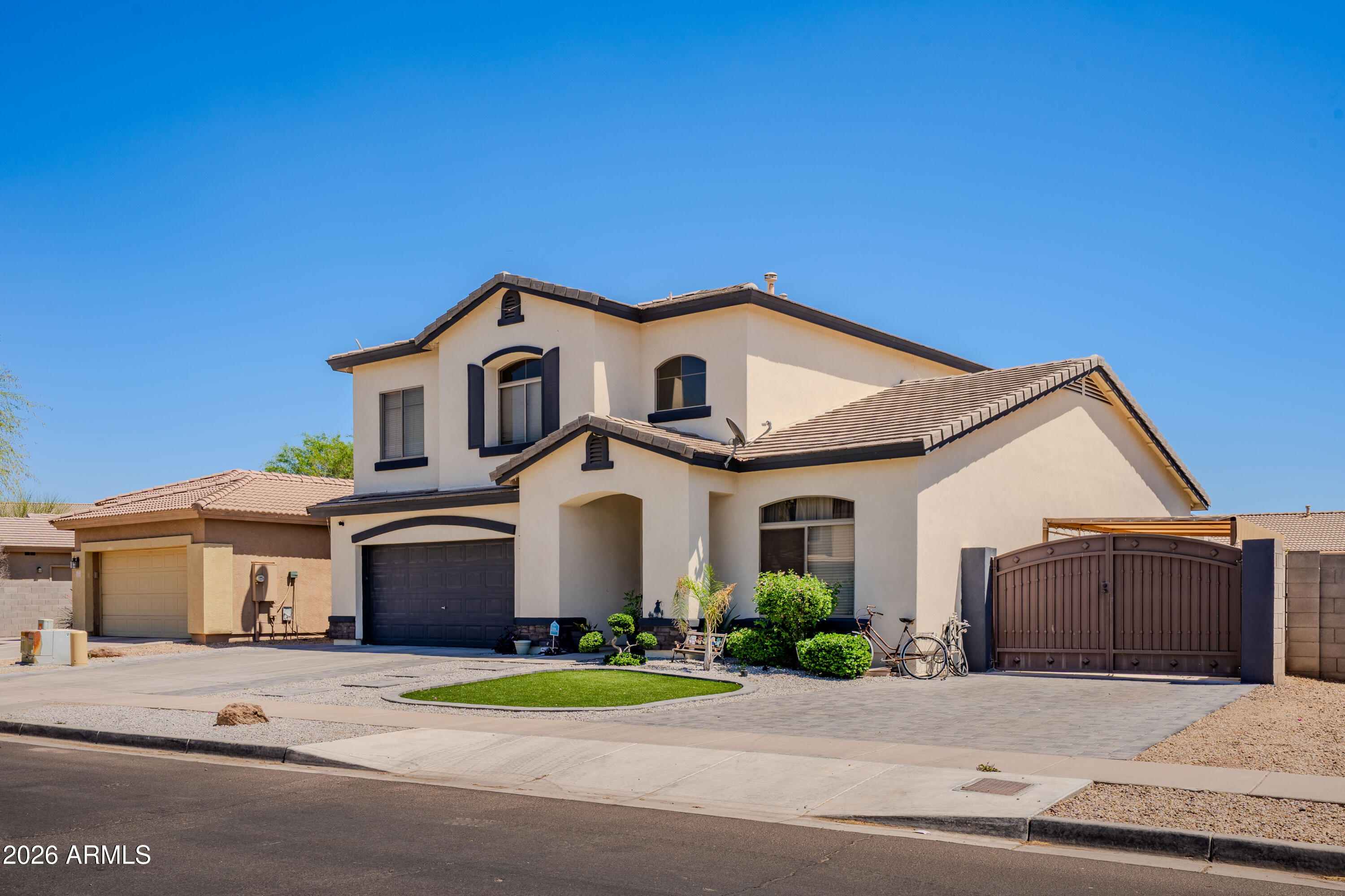 5137 West Grenadine Road Laveen, AZ 85339 - Photo 2 of 53 a front view of a house with a yard and garage