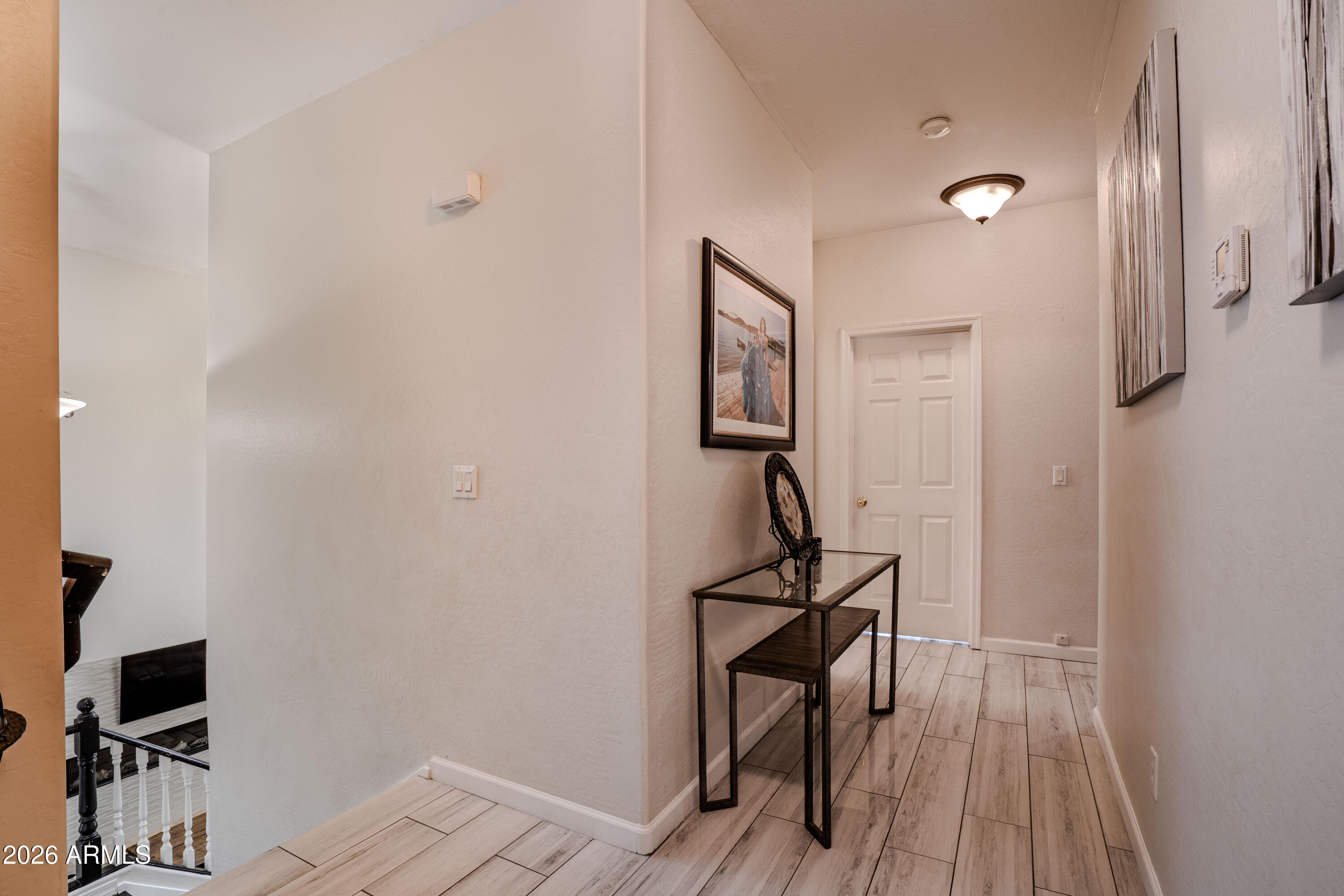 5137 West Grenadine Road Laveen, AZ 85339 - Photo 27 of 53 a view of a hallway with wooden floor and a bathroom