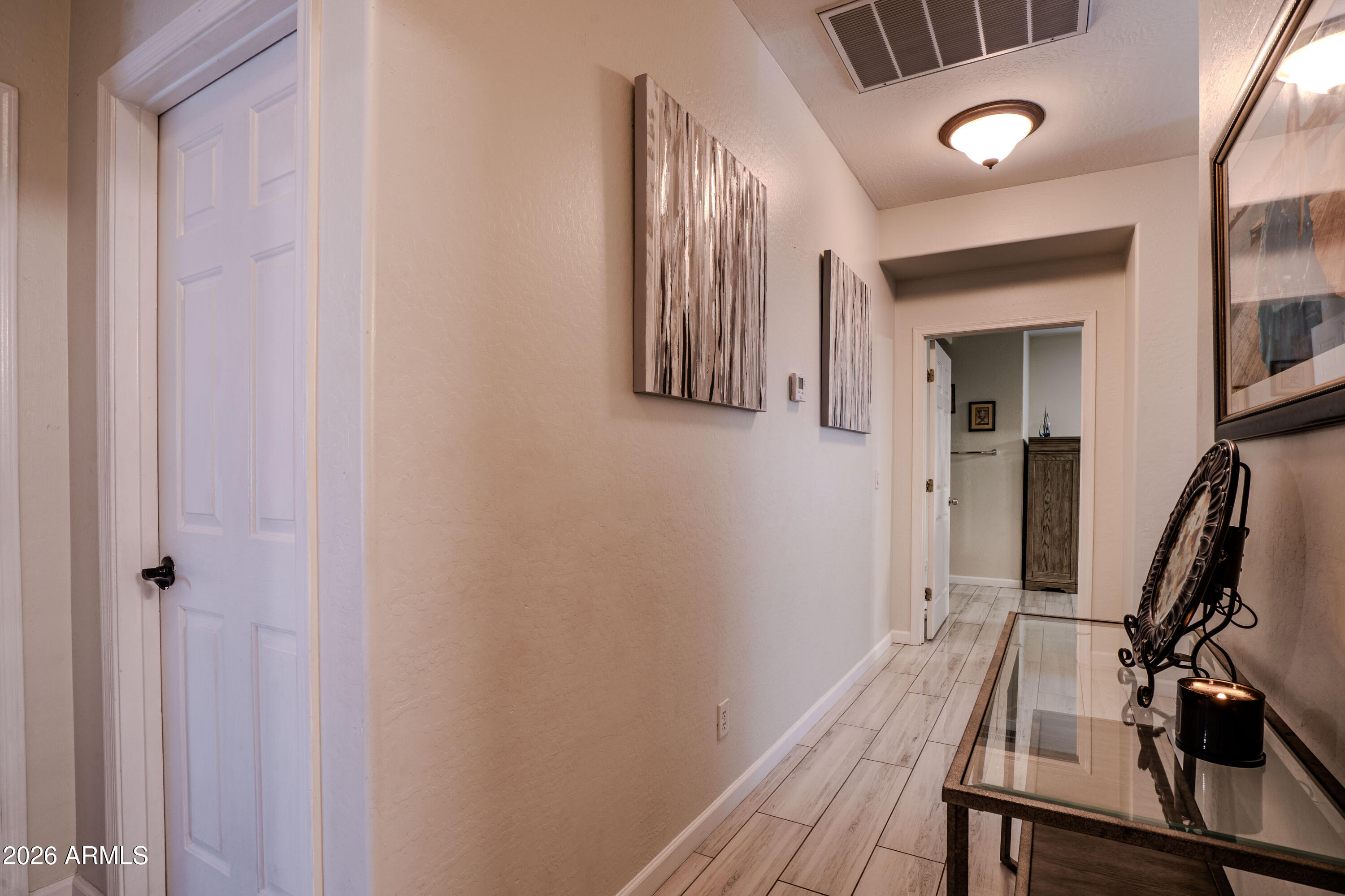 5137 West Grenadine Road Laveen, AZ 85339 - Photo 28 of 53 a view of a hallway with wooden floor and stairs
