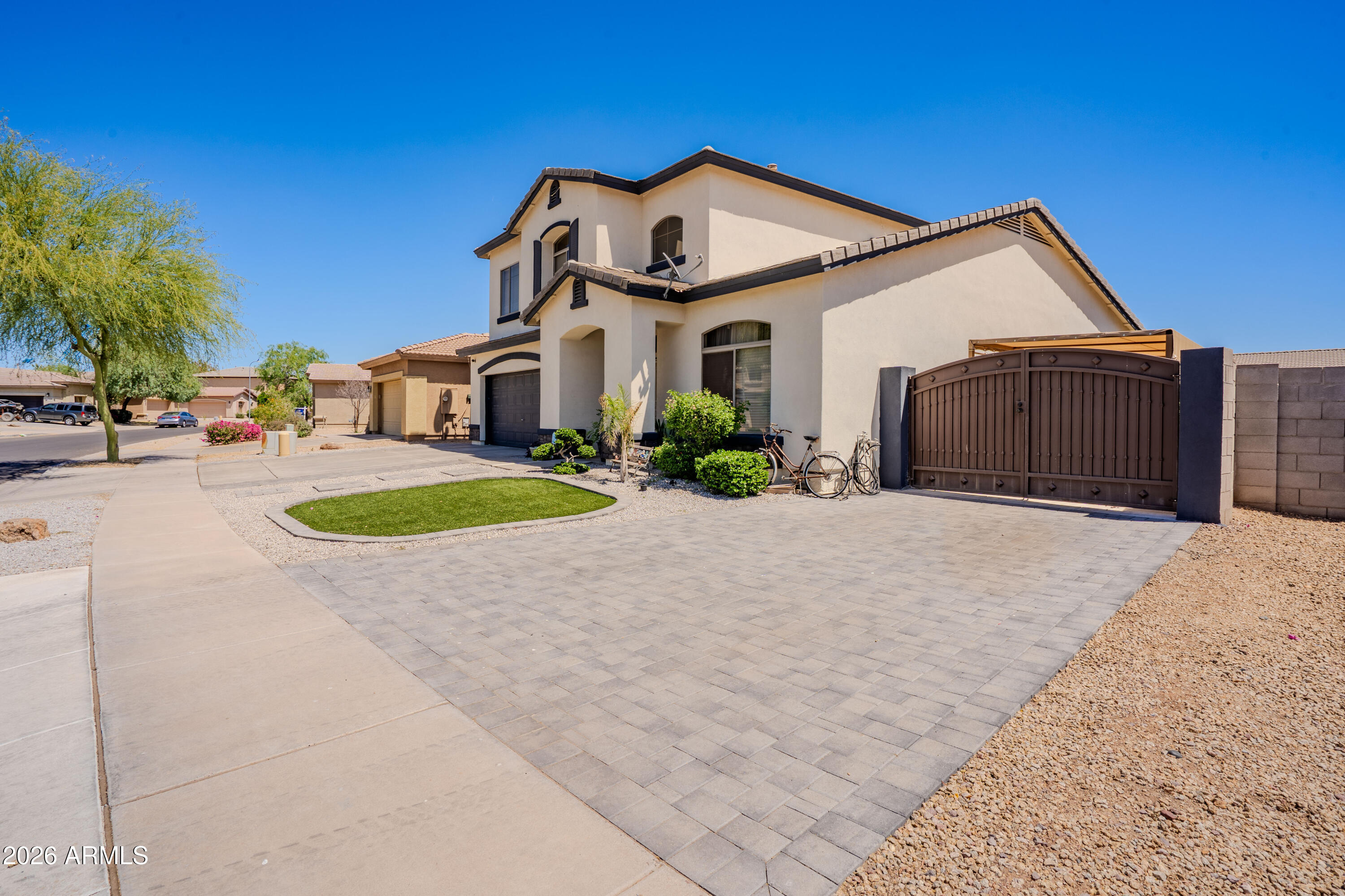 5137 West Grenadine Road Laveen, AZ 85339 - Photo 3 of 53 a front view of a house with a yard and garage