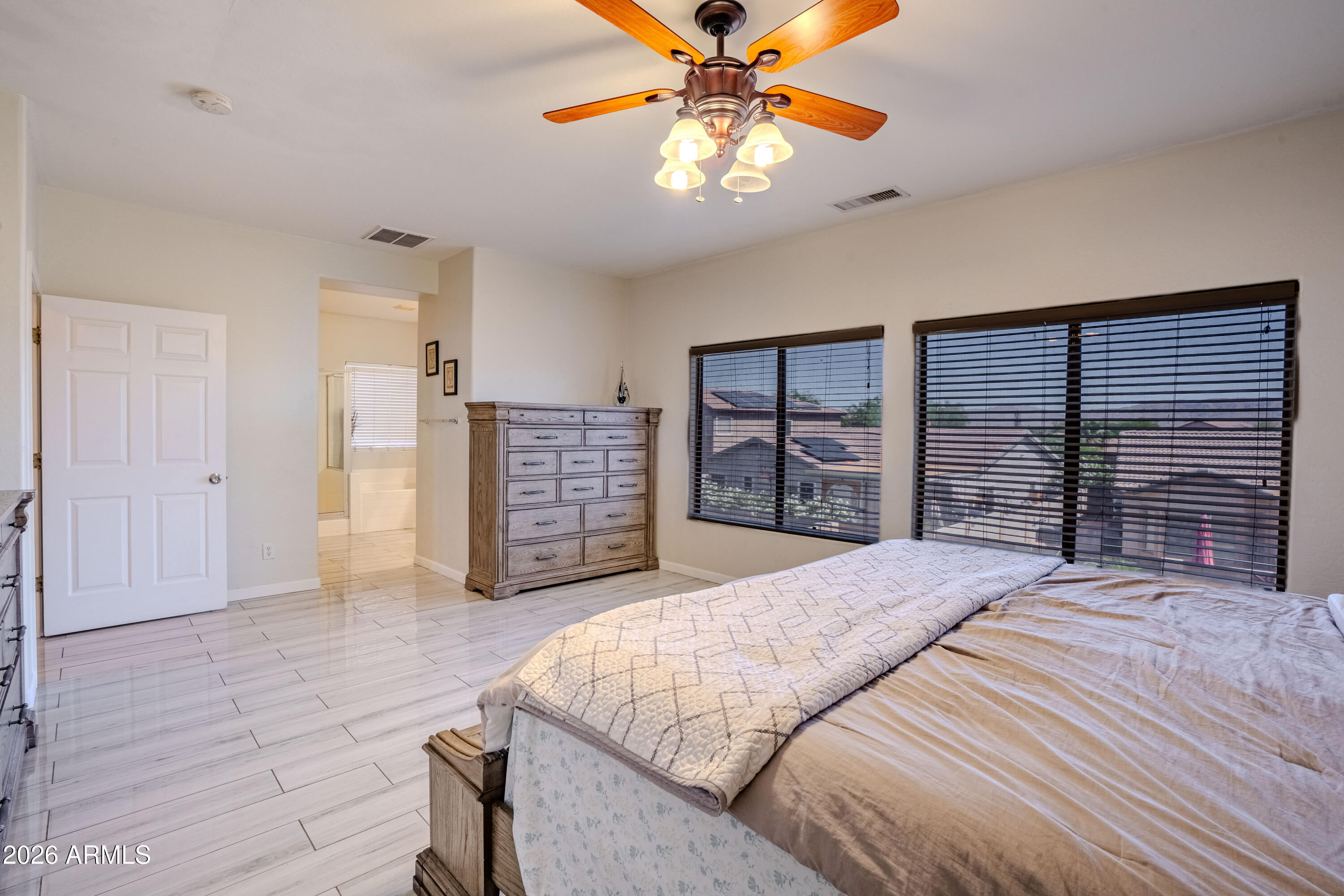 5137 West Grenadine Road Laveen, AZ 85339 - Photo 31 of 53 a bedroom with a large bed and a chandelier