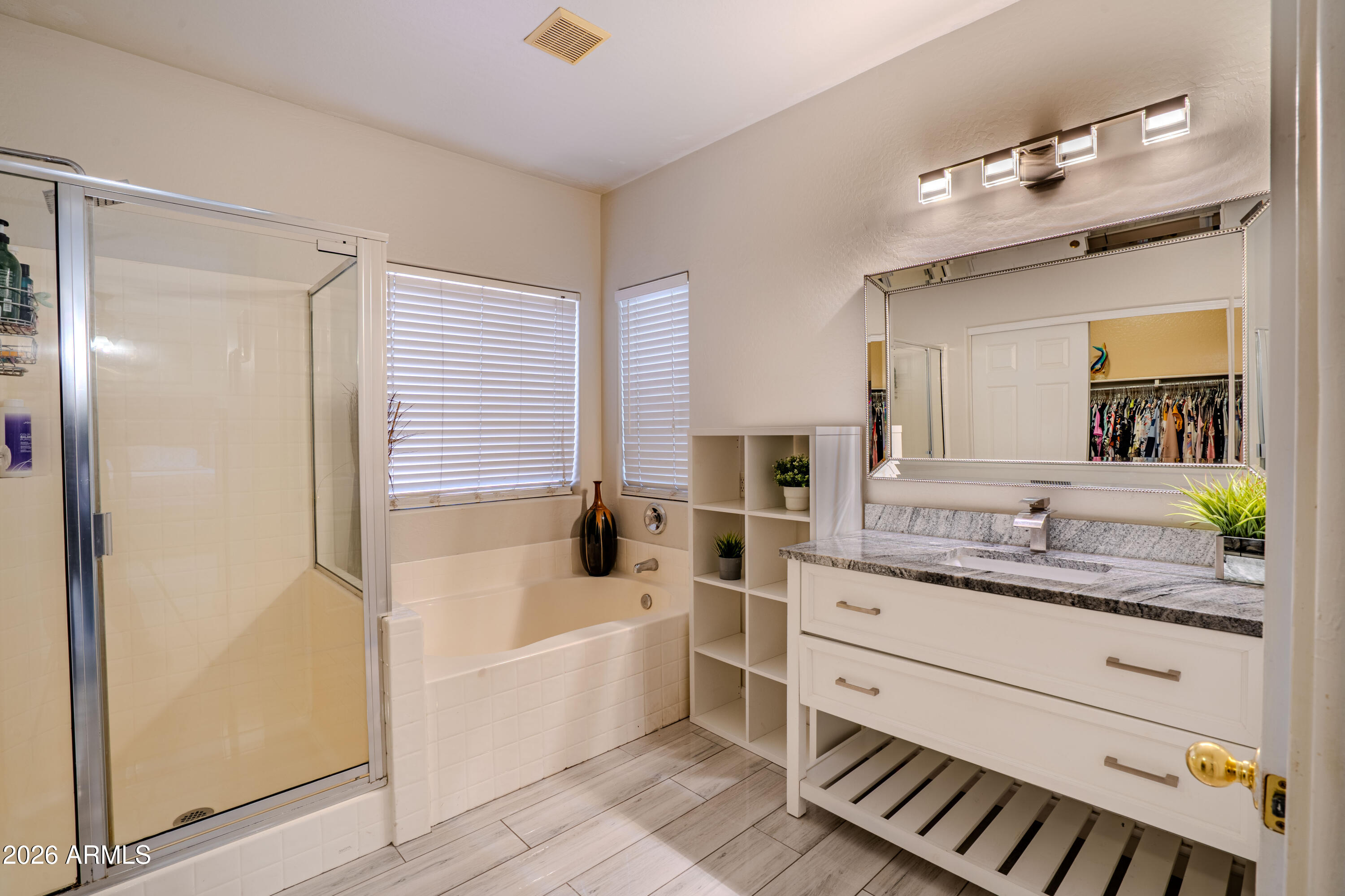 5137 West Grenadine Road Laveen, AZ 85339 - Photo 33 of 53 a bathroom with a granite countertop sink mirror vanity bathtub and a shower