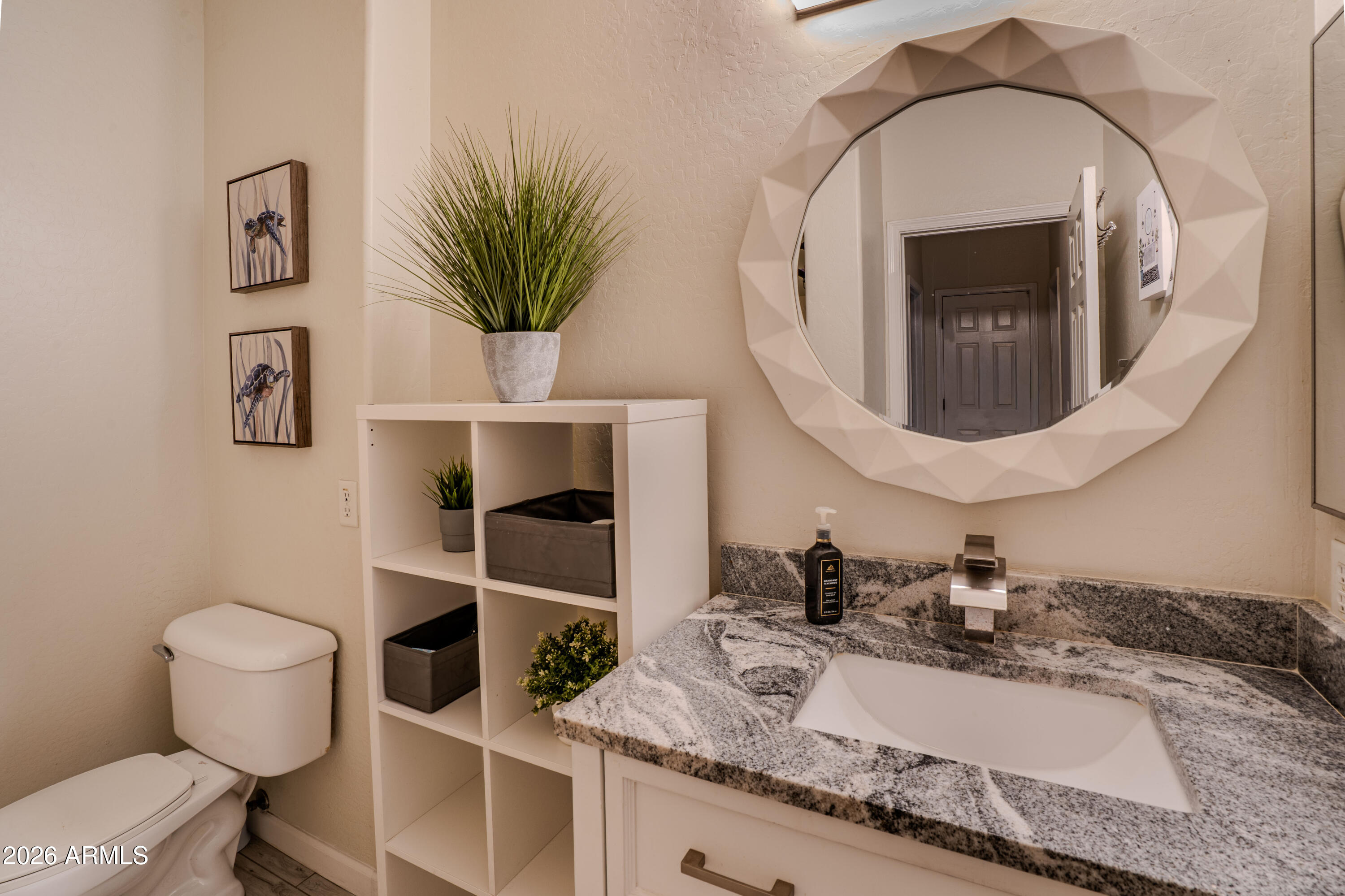 5137 West Grenadine Road Laveen, AZ 85339 - Photo 35 of 53 a bathroom with a granite countertop toilet sink and mirror