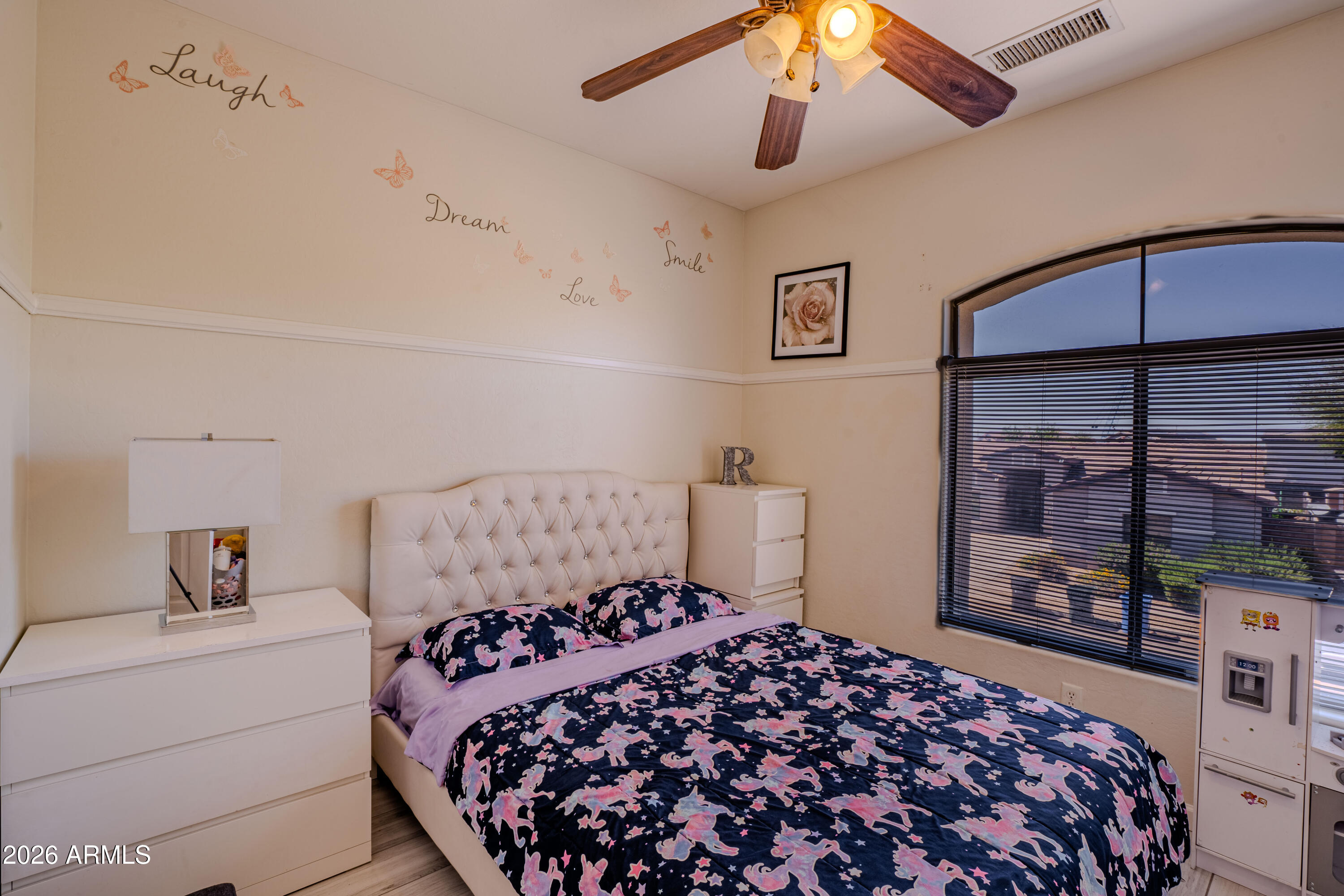 5137 West Grenadine Road Laveen, AZ 85339 - Photo 37 of 53 a bedroom with a large bed and a chandelier