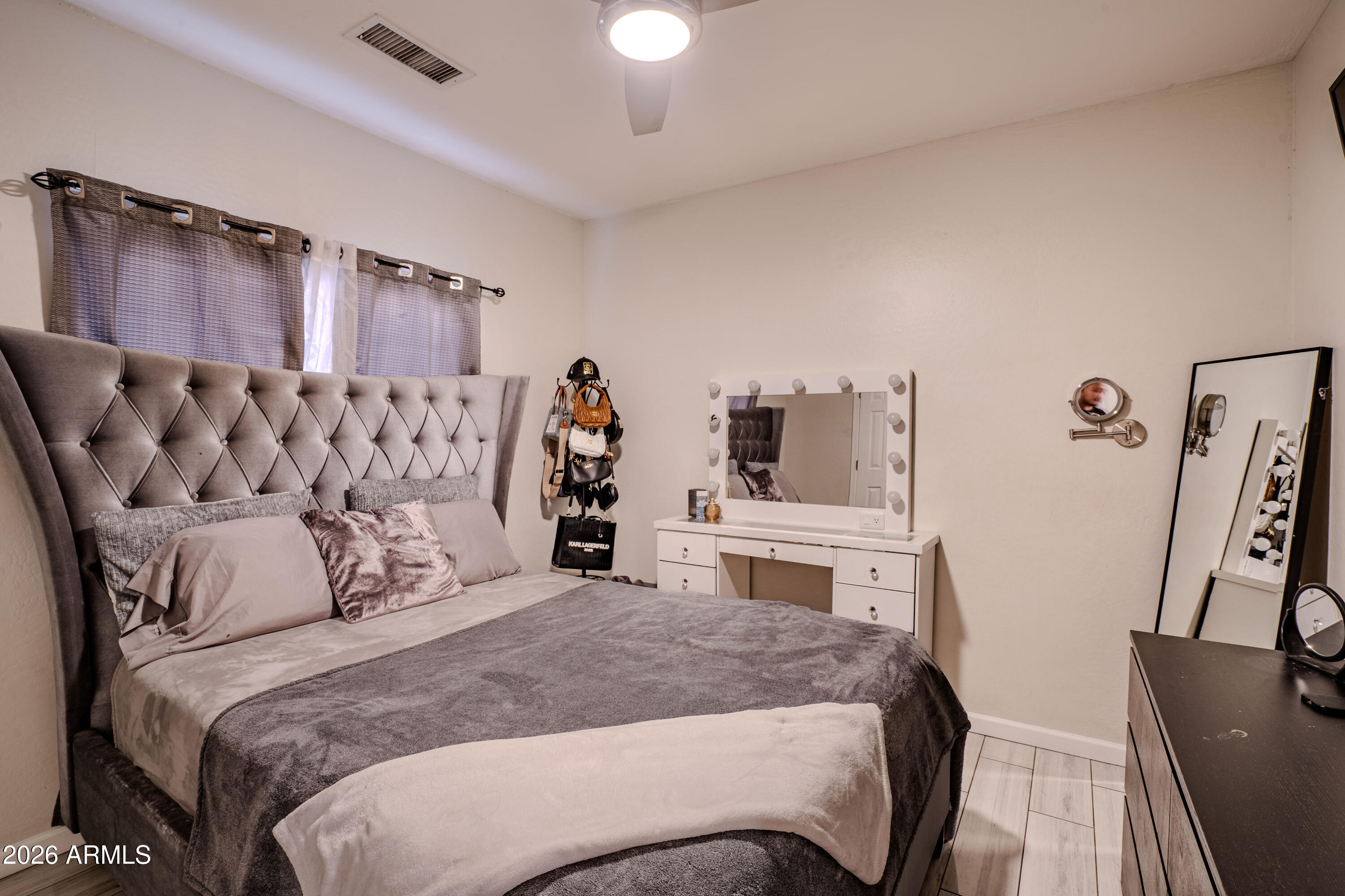 5137 West Grenadine Road Laveen, AZ 85339 - Photo 39 of 53 a bedroom with a bed and a flat tv screen on dresser