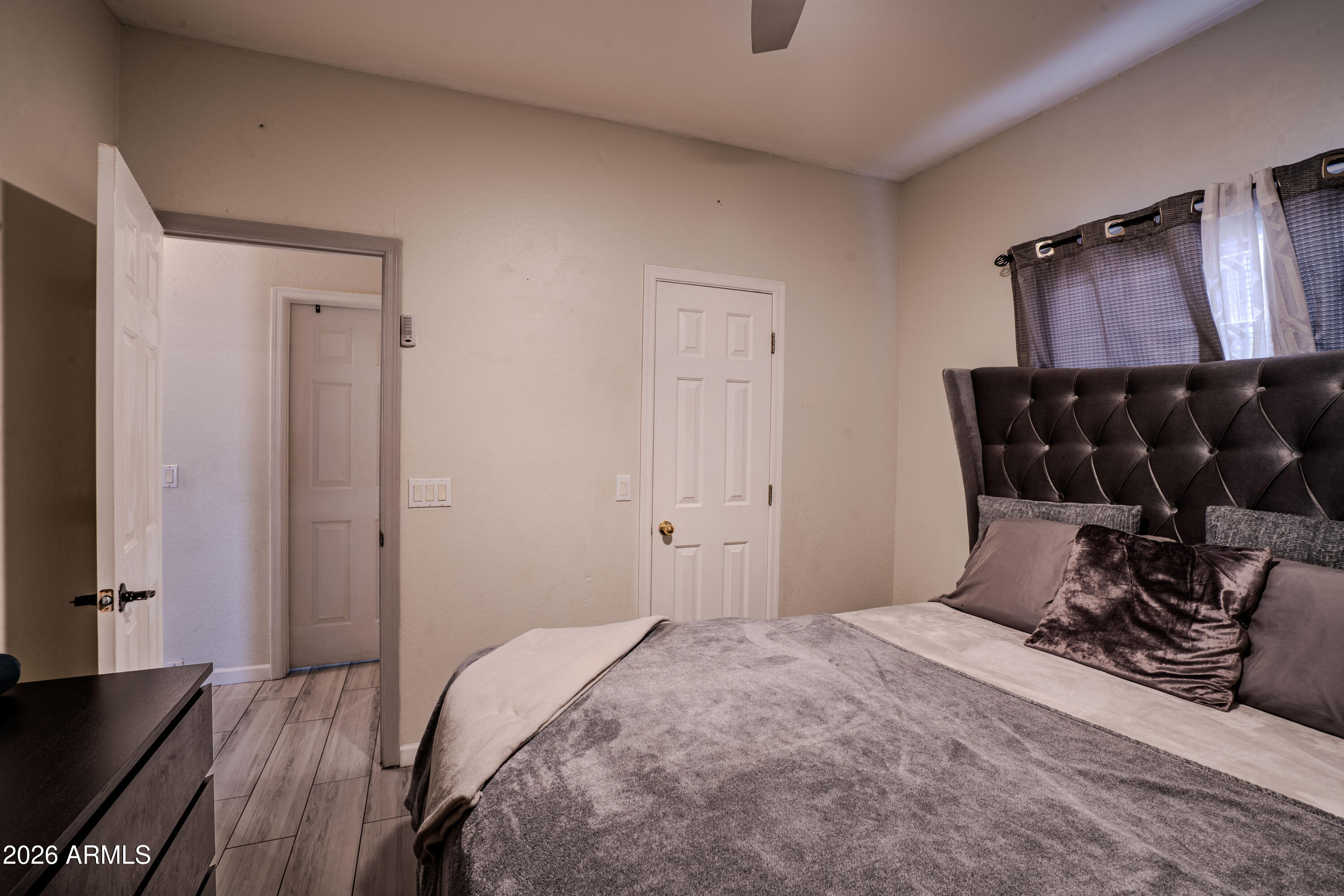 5137 West Grenadine Road Laveen, AZ 85339 - Photo 40 of 53 a bedroom with a bed and wooden floor