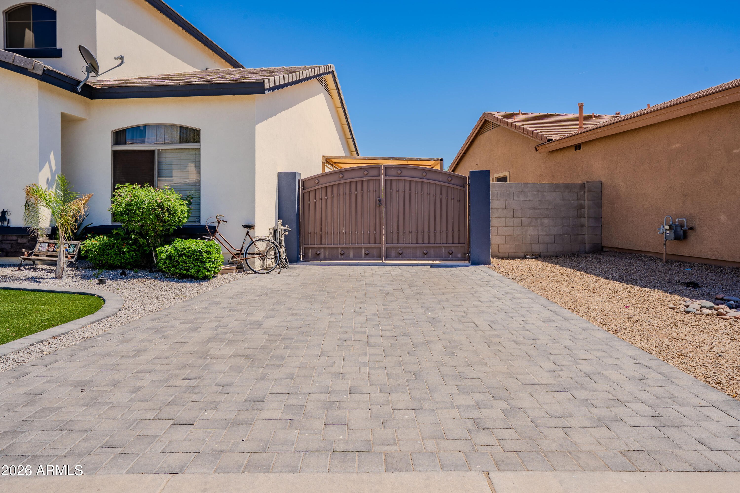 5137 West Grenadine Road Laveen, AZ 85339 - Photo 4 of 53 a view of a house with a yard and potted plants