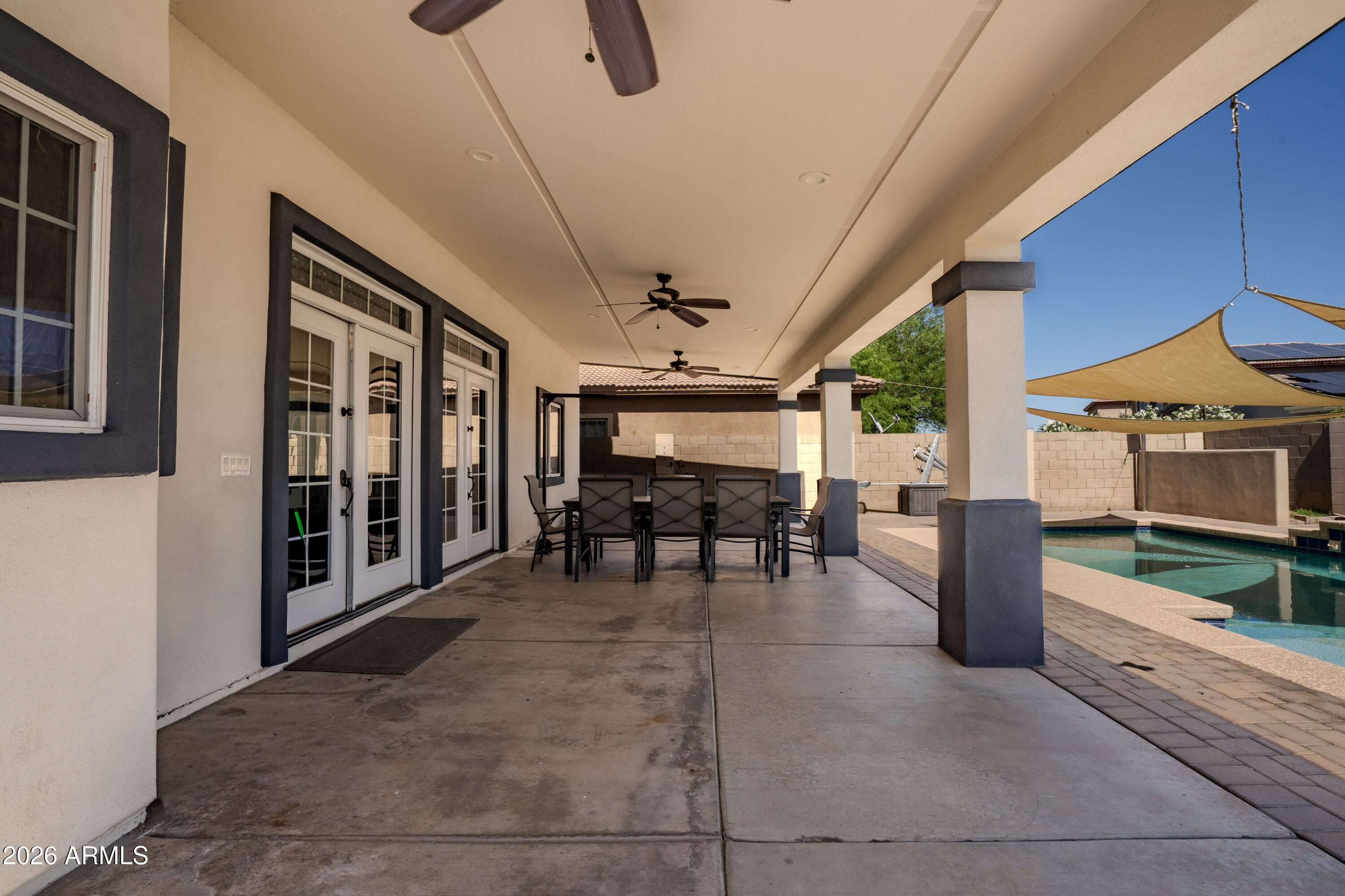 5137 West Grenadine Road Laveen, AZ 85339 - Photo 45 of 53 a view of a porch with furniture and a gate