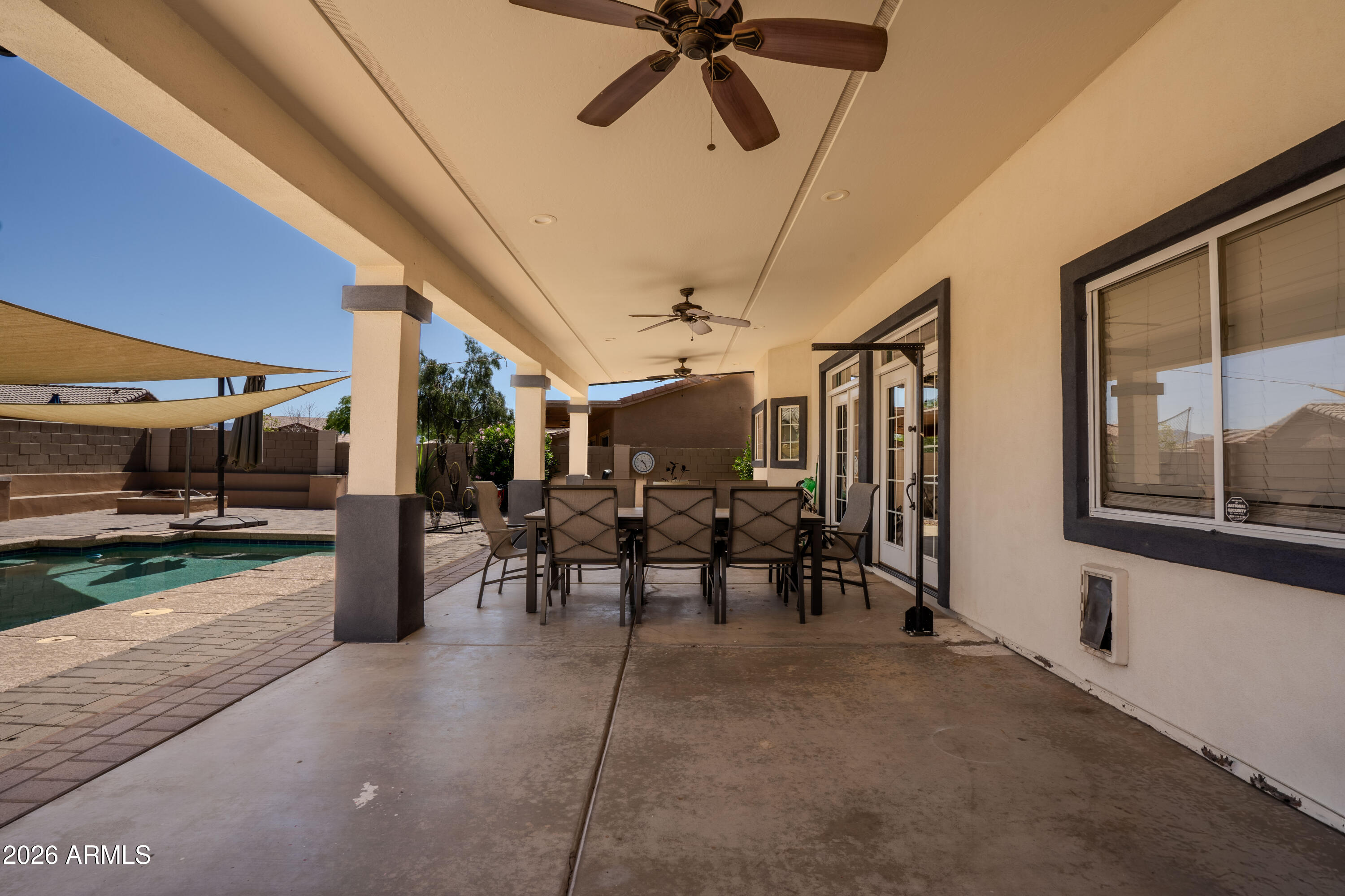 5137 West Grenadine Road Laveen, AZ 85339 - Photo 46 of 53 a view of a porch with a table and chairs
