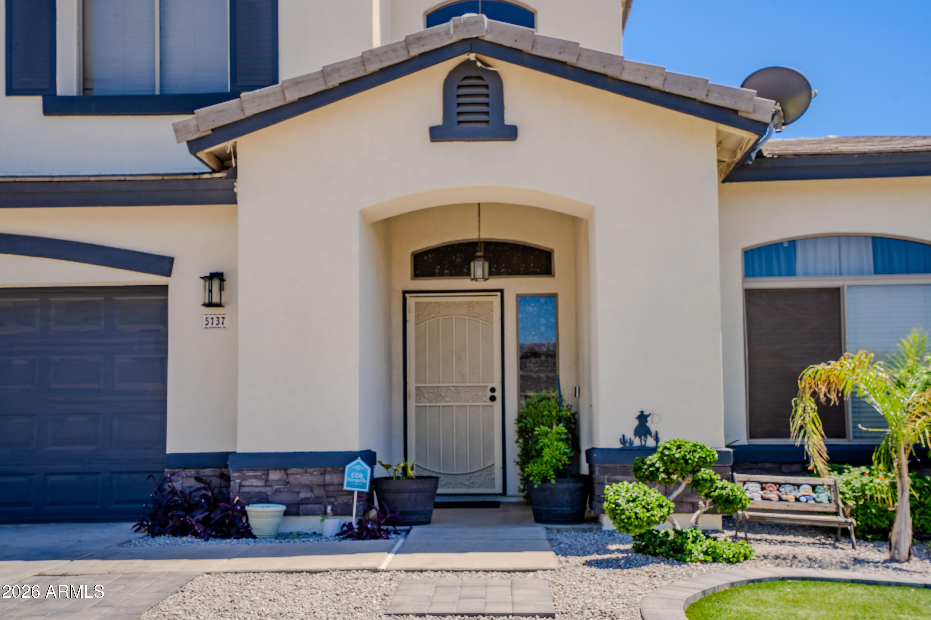 5137 West Grenadine Road Laveen, AZ 85339 - Photo 5 of 53 a front view of a house with garden