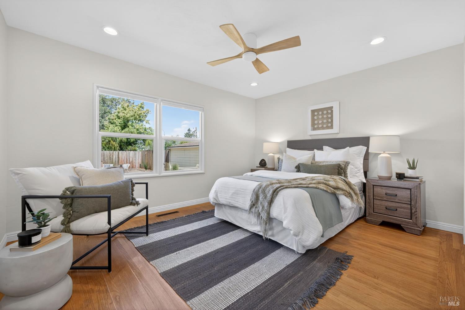 2211 Humboldt Street Santa Rosa, CA 95404 - Photo 36 of 52 a bedroom with a bed and wooden floor