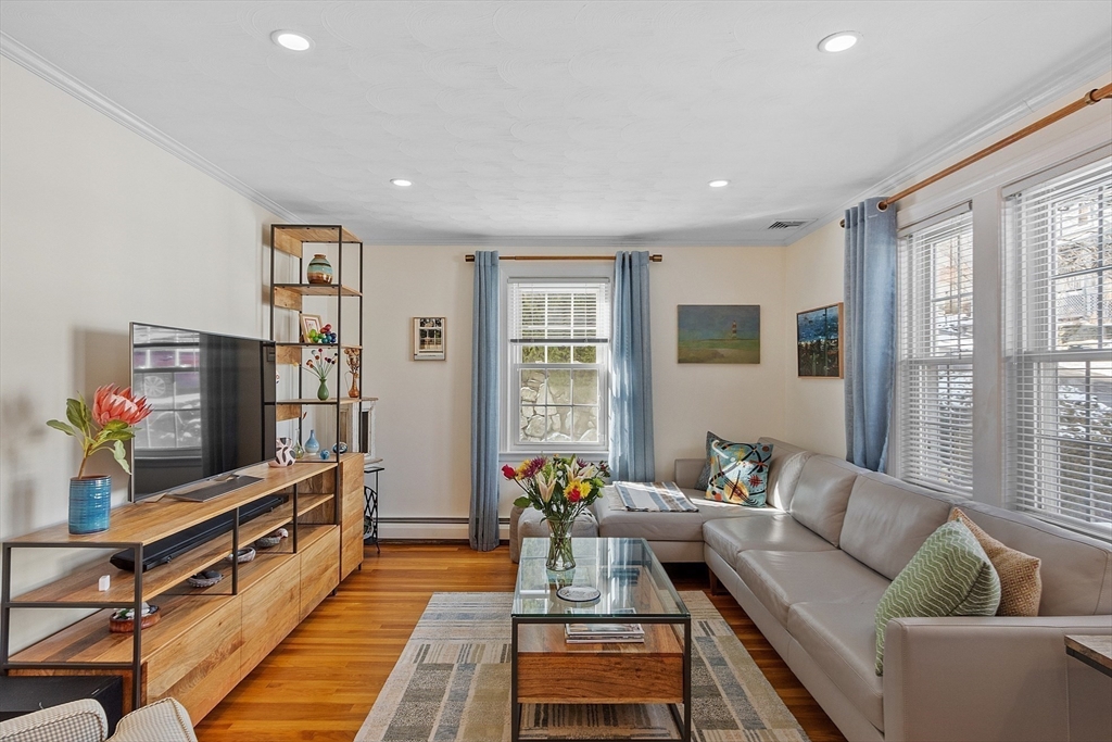88 Menotomy Road Arlington, MA 02476 - Photo 12 of 40 a living room with furniture and a flat screen tv