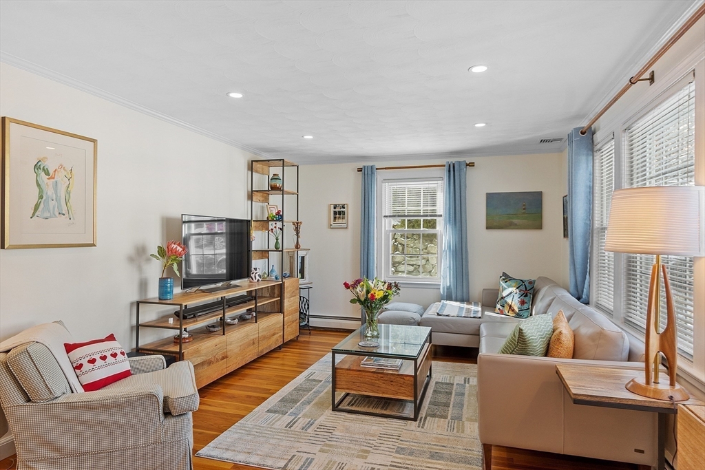 88 Menotomy Road Arlington, MA 02476 - Photo 13 of 40 a living room with furniture and a flat screen tv