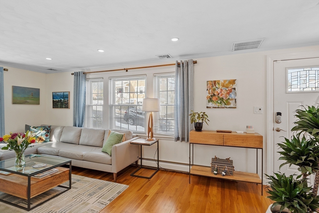 88 Menotomy Road Arlington, MA 02476 - Photo 15 of 40 a living room with furniture and floor to ceiling windows