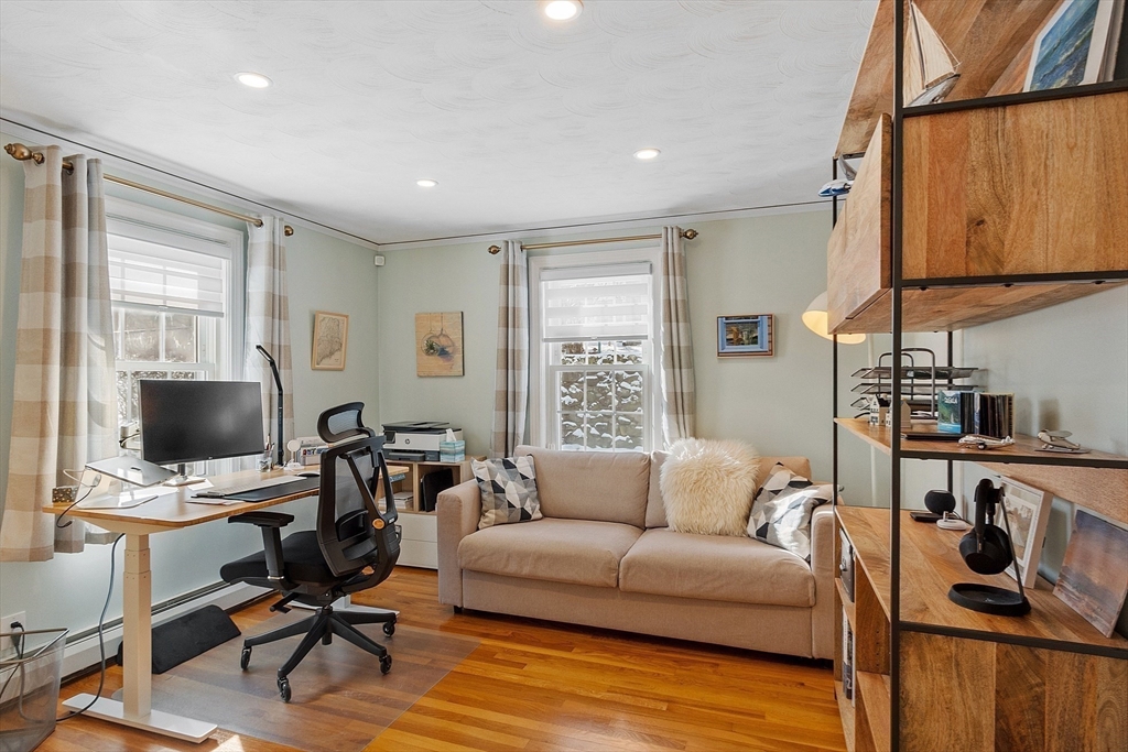 88 Menotomy Road Arlington, MA 02476 - Photo 18 of 40 a living room with furniture a flat screen tv and a window
