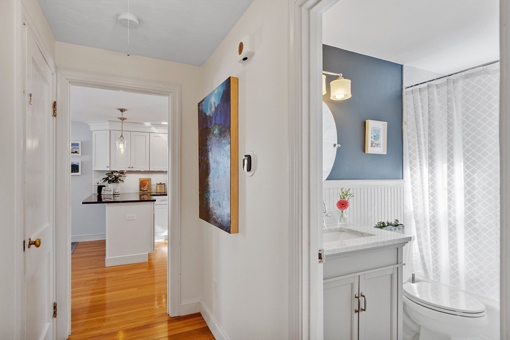 88 Menotomy Road Arlington, MA 02476 - Photo 20 of 40 a kitchen with white cabinets and refrigerator